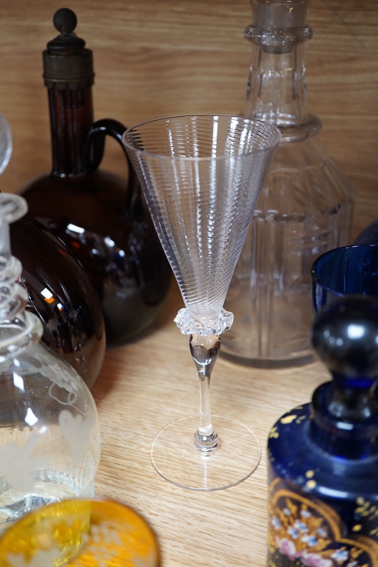 A collection of coloured glass flagons, glasses and bottles etc. (18). Tallest decanter and stopper 25cm high.